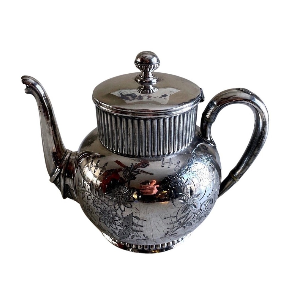 Victorian Aesthetic Movement Wilcox silver-plated teapot with floral engravings.